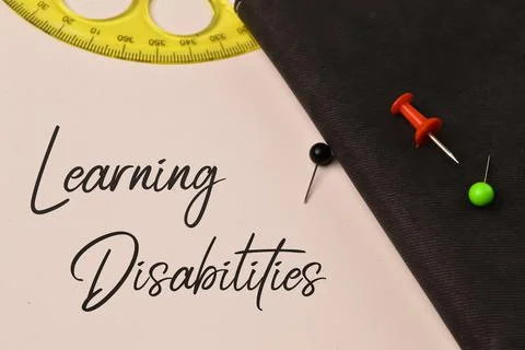 Top view of notebook written with text LEARNING DISABILITIES. Stock Photos