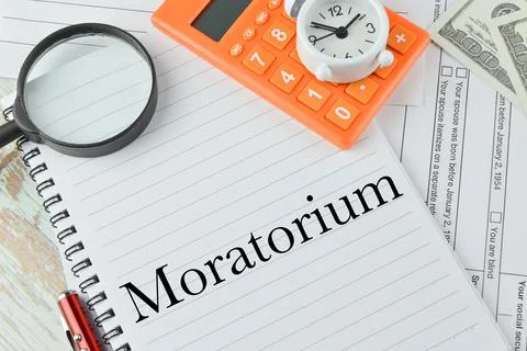 Top view of notebook written with text MORATORIUM. Stock Photos