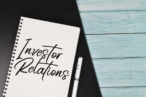 Top view of notebook written with text INVESTOR RELATIONS 스톡 사진