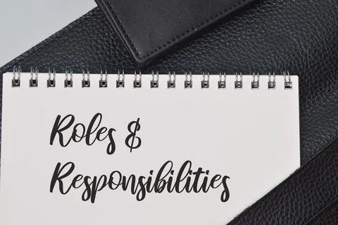 Top view of notebook written with text ROLES and RESPONSIBILITIES. Business c Stock Photos