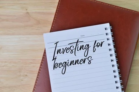 Top view of notebooks written with text INVESTING FOR BEGINNERS. Stock Photos