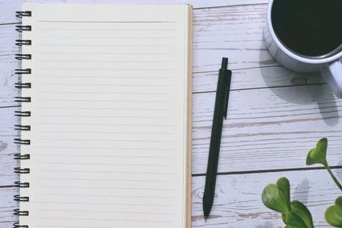 Top view of notepad and pen with cup of coffee Stock Photos