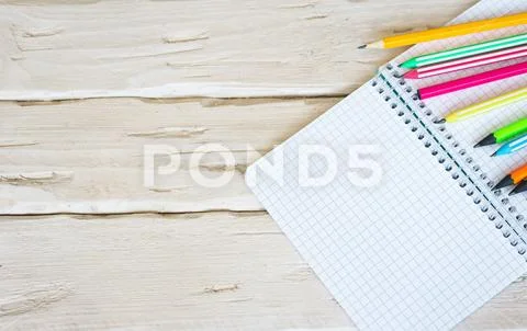 Top view notepad with a blank page in a cage with a black push button ...