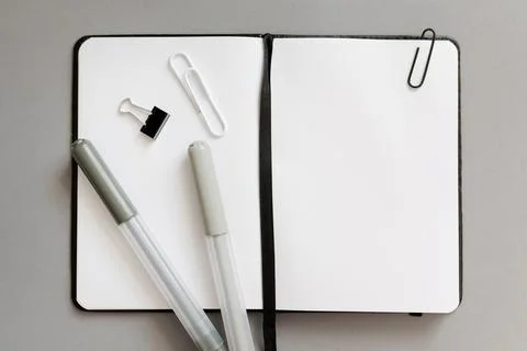 Top view of notepad with blank pages and pencils over grey Stock Photos