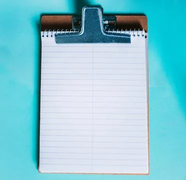 Top view of notepad on isolated background. Note book on clipboard on color.. Stock Photos