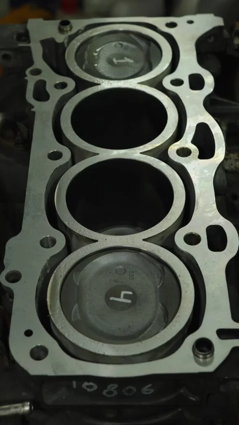 Top view of numbered pistons inside an open engine block. Stock Footage 340336400