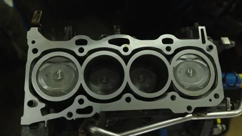Top view of numbered pistons inside an open engine block. Stock Footage 340336430