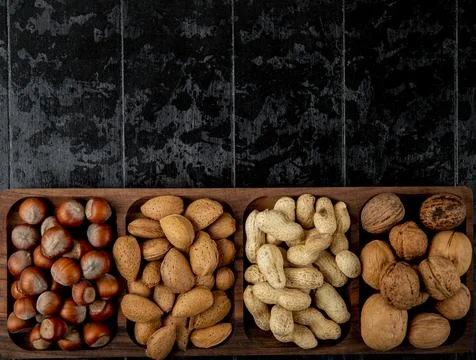 Top view of nut mix hazelnuts almond and peanuts in shell on black backgrou.. Stock Photos