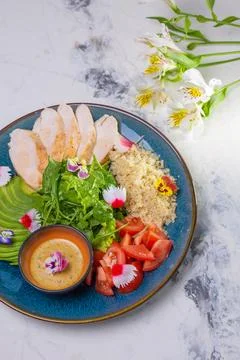 Top view of nutritious lunch with grilled chicken, salad, tomatoes, avocado,  Stock Photos
