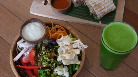 Top view of nutritious veggie lunch meal on the table, vegan bowl, yummy falafel Stock Footage 169832906