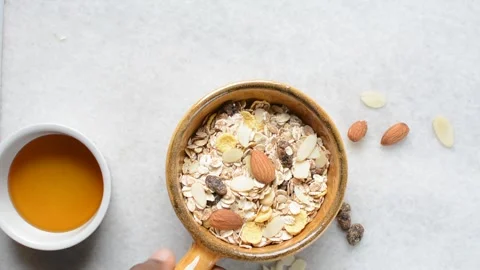 Top view of oat muesli in a brown terracotta ramekin with handle Stock Footage 279155295