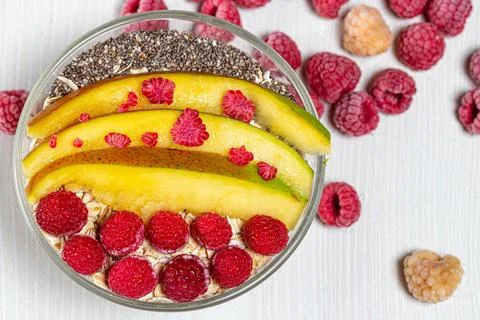Top view oatmeal with mango slices, raspberries and Chia seeds Stock Photos