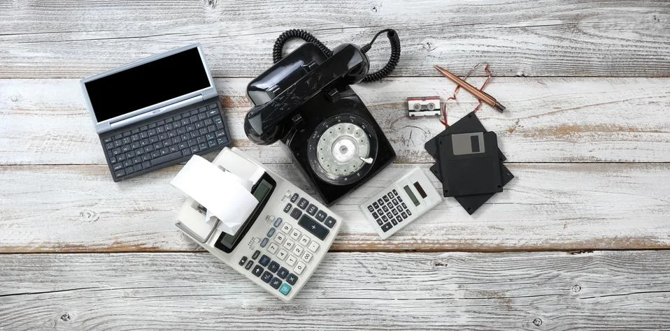 Top view of obsolete technologies that includes rotary dial phone and old com Stock Photos