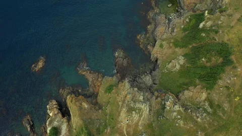 Top view by Ocean with blue waves crashing coastline cliff Stock Footage 109611940