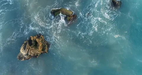 Top view of ocean blue waves crashing coastline cliff drone footage Stock Footage 123112236