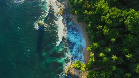 Top view of ocean blue waves crashing against the rocks and the pier, tropics Stock Footage 148674870
