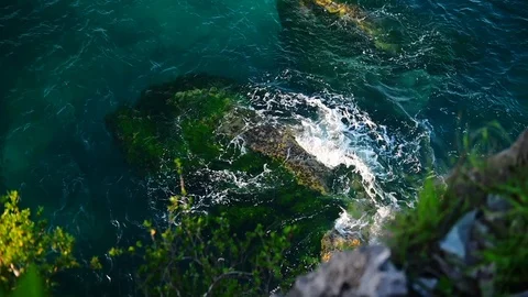 Top view of ocean waves crashing on rock wild coast with spray and foam. Stock Footage 127079182