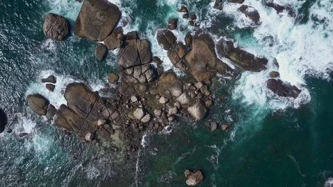Top view of ocean waves hitting a rocks drone footage Stock Footage 84714966