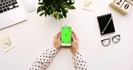 Top View On The Office Desk And White Smartphone With Green Screen And Female Stock Footage