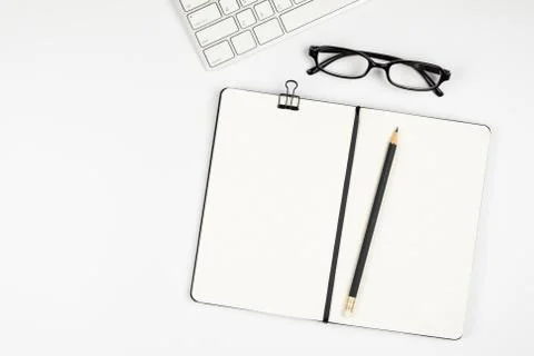 Top view of office desk with empty notebook and pencil Stock Photos