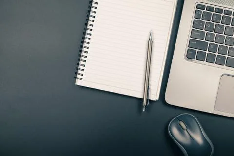 Top view of office desk with notebook pen and laptop Stock Photos