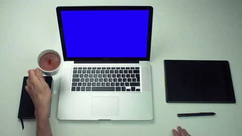 Top view at office desk with notepad, laptop, digital tab and cup of tea Stock Footage 82887945