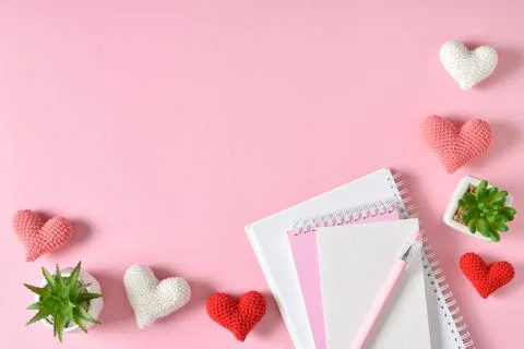 Top view of the office desk. Romantic atmosphere. A notebook with hearts and  Stock Photos