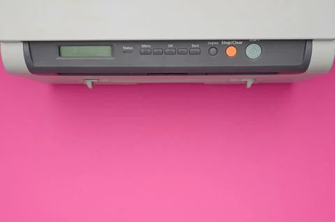 Top view of an office printer on a pink background.Copy space.Office equipment. Stock Photos