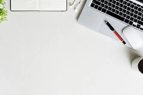 Top view office stuff with notepad, laptop and coffee cup mouse notepad shot. Stock Photos