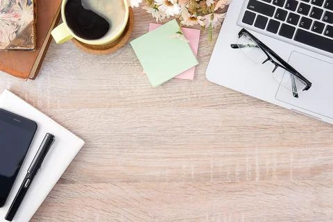 Top view office stuff with notepad, laptop and coffee cup mouse notepad shot. Stock Photos