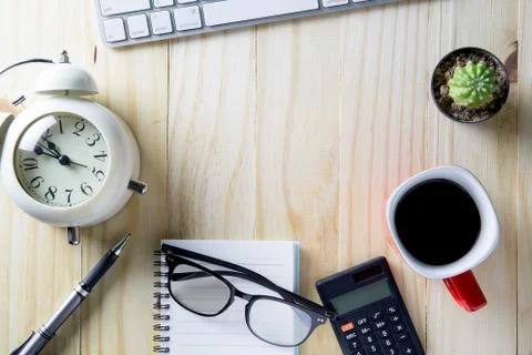 Top view of office table, cup of coffee, pen, calculator, keyboard. Stockfoto's