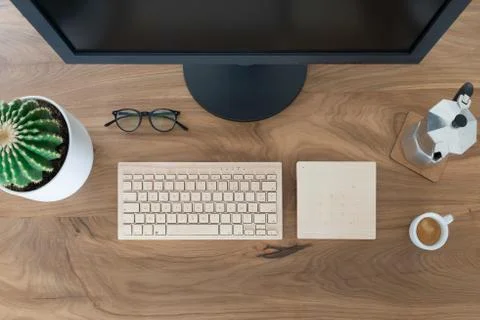 Top view office table desk. Workspace with a monitor screen, a wooden keyboard Stock-Fotos