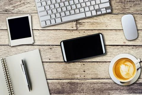 Top view office table with notepad, computer and coffee cup and computer mo.. Stock Photos