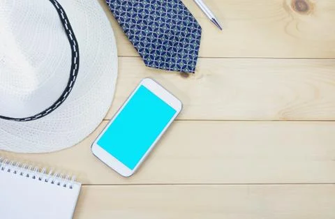 Top view office table with paper, necktie, hat, smart phone and pen for busin Stock Photos