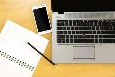 Top view of office Table top with laptop computer, mobile smartphone. Stock Photos