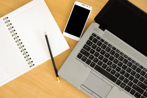 Top view of office Table top with laptop computer, mobile smartphone. Stock Photos