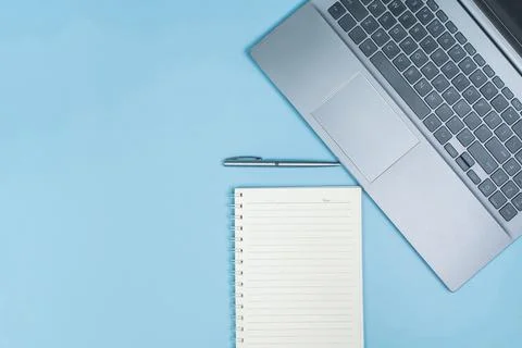 Top view of Office Table top with laptop computer, pen and notebook with spac 스톡 사진
