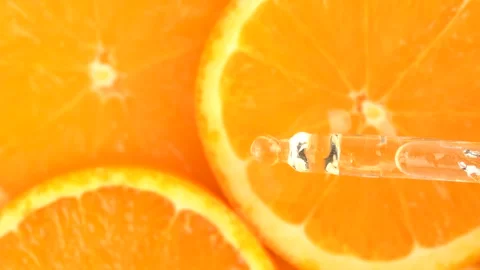 Top view of oily orange essence drop from pipette into orange slices. Essen.. Stock Footage 273676773