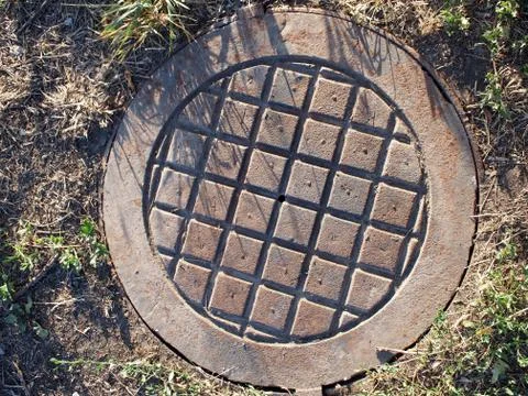 Top view of an old and rusty manhole Stock Photos