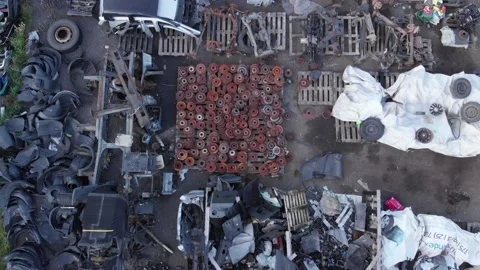 Top view of old assorted car parts lying on pallets on asphalt under the open Stockbeeldmateriaal 150862677