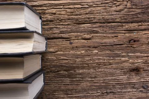 Top view of old book stack over old grunge natural wooden shabby Stock Photos