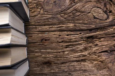 Top view of old book stack over old grunge natural wooden shabby Stock Photos