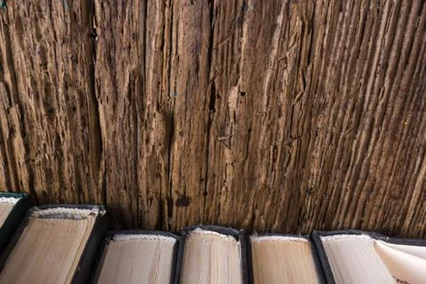 Top view of old book stack over old grunge natural wooden shabby Stock Photos