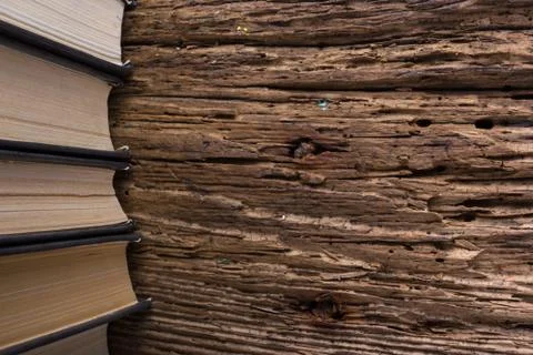 Top view of old book stack over old grunge natural wooden shabby Stock Photos