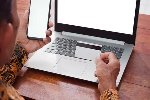 Top view Old man doing financial transaction with the white blank credit card, Stock-Fotos