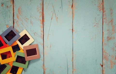 Top view of old slides frames over wooden background Stock Photos