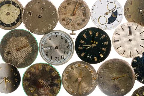 Top view on old worn clock dials on white isolated studio background. Aged Stock Photos