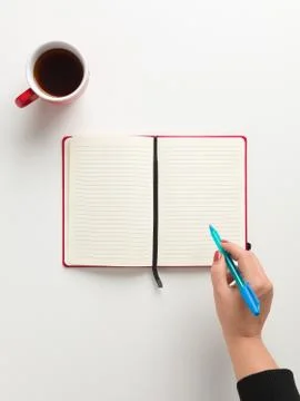 Top view of an open blank red notebook in the center, a red cup of coffee, an 写真素材