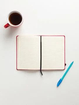 Top view of an open blank red notebook in the center, a red cup of coffee and Stock Photos