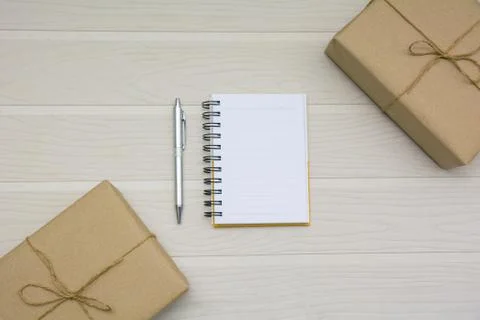 Top view of open book. Book open with pen and boxes on wooden background and  Stock Photos